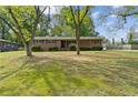 Charming brick home with green shutters and mature landscaping in a desirable neighborhood at 509 Woodland Ln, Lawrenceville, GA 30043