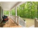 A cozy front porch with seating and serene views of the surrounding lush greenery at 569 Hale Mountain Ct, Hiram, GA 30141