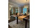 View of dining room featuring elegant lighting, wood floors, and a decorative rug at 4586 Smoke Rise Ln, Marietta, GA 30062
