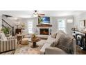 Cozy living room featuring shiplap walls, fireplace, stylish furnishings, and an abundance of natural light at 4586 Smoke Rise Ln, Marietta, GA 30062