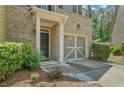 Inviting home exterior featuring a well-maintained lawn, front door, and attached one-car garage at 1406 Dolcetto Nw Trce # 13, Kennesaw, GA 30152
