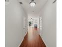 Bright hallway with wood floors leading to a cozy living room with a fireplace at 1406 Dolcetto Nw Trce # 13, Kennesaw, GA 30152