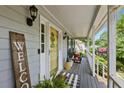 Cozy covered front porch with wooden flooring, welcoming decor, and ample space for relaxation at 1767 Hunters Sw Trce, Lilburn, GA 30047