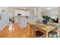 Bright white kitchen with modern appliances, a center island, and an adjacent breakfast nook at 2185 Arbor Chase, Cumming, GA 30041