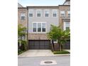 Attractive multi-story brick townhome featuring an attached two-car garage and traditional architectural details at 3592 Parkhaven Pl, Brookhaven, GA 30319
