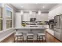 Bright eat-in kitchen features white cabinetry, quartz countertops, stainless appliances and a breakfast bar at 3592 Parkhaven Pl, Brookhaven, GA 30319