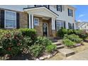 Charming entrance with stone facade, blossoming shrubs, and a walkway leading to the front door at 3811 Holliwell Pass, Cumming, GA 30040