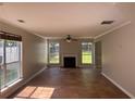 Bright living room featuring a fireplace, neutral walls, and large windows that provide abundant natural light at 4081 Liberty Hill Dr, Norcross, GA 30093