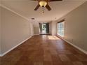 Spacious living room featuring tile flooring, a ceiling fan, and natural light from a large window at 4081 Liberty Hill Dr, Norcross, GA 30093