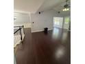 Spacious living room featuring hardwood flooring, a vaulted ceiling, and ample natural light at 955 Tributary Way, Dacula, GA 30019