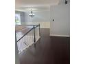 Staircase that leads to a spacious living room with hardwood flooring and neutral paint at 955 Tributary Way, Dacula, GA 30019
