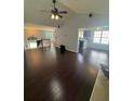 Open-concept living space with hardwood floors, vaulted ceilings, and natural light at 955 Tributary Way, Dacula, GA 30019