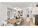 Bright dining room featuring a wood table with seating for six and stylish decor at 5230 Hyde Rd, Cumming, GA 30040