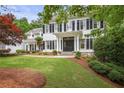Classic two-story home featuring a well-kept lawn, mature landscaping, and traditional architectural features at 4356 N Buckhead Ne Dr, Atlanta, GA 30342