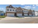 Inviting townhomes showcase a blend of brick and siding, with private garage access and neat lawn areas at 867 Eagle Avenue, Riverdale, GA 30296
