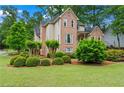 Landscaped front yard showcasing the brick exterior of this beautiful two-story home at 1145 Cool Springs Nw Dr, Kennesaw, GA 30144