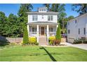 Charming two-story home with a manicured lawn, landscaped yard, and inviting front porch at 3042 Jefferson St, Atlanta, GA 30341