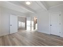 Bedroom featuring neutral walls, wood flooring, and a view into the hallway and bathroom at 4055 Hosch Retreat Dr, Buford, GA 30519