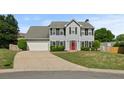 Well-maintained home featuring a large driveway and inviting front lawn at 406 Mount Vernon Ct, Woodstock, GA 30189