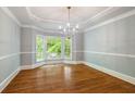 Elegant dining room features hardwood floors, crown molding, and a bay window with views of nature at 4109 Brookview Se Dr, Atlanta, GA 30339
