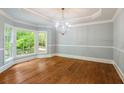Elegant dining room features hardwood floors, crown molding, and a bay window with views of nature at 4109 Brookview Se Dr, Atlanta, GA 30339