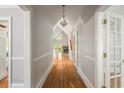 Inviting hallway with hardwood floors, opening to a view of the living room fireplace at 4109 Brookview Se Dr, Atlanta, GA 30339