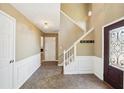 Inviting home foyer with hardwood floors, a staircase, decorative lighting, and modern decor at 1745 Fairburn Dr, Cumming, GA 30040