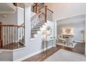 Elegant foyer with a staircase, hardwood floors, and view of a formal sitting area at 305 High Branch Way, Roswell, GA 30075