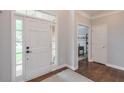 Welcoming foyer with hardwood floors, light gray walls, and a glimpse into other rooms at 305 High Branch Way, Roswell, GA 30075