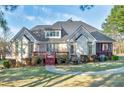 Expansive backyard featuring a deck, screened porch, and lush lawn at 415 Oxmoor Lake Dr, Mcdonough, GA 30252