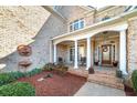 Charming front porch with stately columns and welcoming entryway at 415 Oxmoor Lake Dr, Mcdonough, GA 30252