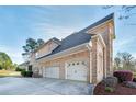 Spacious three-car garage with ample driveway space, perfect for parking at 415 Oxmoor Lake Dr, Mcdonough, GA 30252
