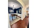 Formal dining room featuring hardwood floors, wainscoting, and a stylish light fixture at 4832 Batiste Nw Ln, Acworth, GA 30101