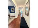 Inviting hallway with hardwood floors, stylish mirror, and a cozy bench seat offers a warm welcome at 4832 Batiste Nw Ln, Acworth, GA 30101