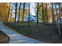 Two story home with vinyl siding and a long driveway leading to the residence at 7205 Jonsway, Cumming, GA 30041