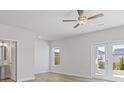 Bright bedroom with wood flooring, neutral paint, and double doors to the outside at 853 Pensive Run, Dacula, GA 30019