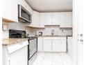 Modern kitchen featuring white cabinets, stainless steel appliances, and granite countertops for a stylish and functional space at 2576 Flat Shoals Dr, Decatur, GA 30034