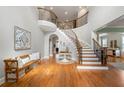 Grand foyer with a curved staircase, hardwood floors, and an elegant entryway table at 3810 Sweat Creek Run, Marietta, GA 30062