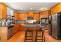 Well-equipped kitchen with stainless steel appliances, a center island, and warm wood cabinets, great for cooking at 712 Crimson Morning Vw, Canton, GA 30114