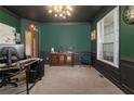 Inviting home office with dark green walls, large window, and stylish furniture, ideal for working from home at 712 Crimson Morning Vw, Canton, GA 30114