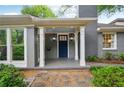 Charming front porch with white columns, a blue door, hanging lanterns, and stone walkway at 25 Standish Nw Ave, Atlanta, GA 30309