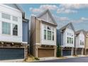 Beautiful townhome with stone accents, a two-car garage, and manicured landscaping at 569 Mirrormont Se Dr, Smyrna, GA 30080