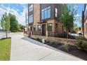 Townhome with brick exterior, black metal accents, small front yard and nice sidewalk at 1122 W Marietta St, Atlanta, GA 30318