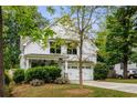 Charming two-story home featuring a white exterior, attached garage, and well-manicured landscaping at 1378 Lochland Se Rd, Atlanta, GA 30316