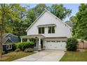 Charming two-story home featuring a white exterior, attached garage, and well-manicured landscaping at 1378 Lochland Se Rd, Atlanta, GA 30316