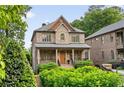 Elegant two-story brick home with manicured landscaping and a charming covered porch at 2017 Harts Mill Ne Rd, Chamblee, GA 30341