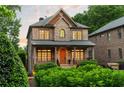 Lovely brick home with a covered porch and beautifully manicured hedges at 2017 Harts Mill Ne Rd, Chamblee, GA 30341