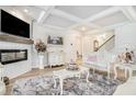 Elegant living room with a fireplace, coffered ceiling, and luxury furniture at 35 Henson Farm Dr, Loganville, GA 30052