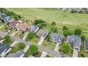 Aerial view of a single Gathering home with a well-maintained lawn and a nearby green space surrounded by other residences at 5375 Glenhaven Dr, Cumming, GA 30041