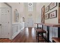 Bright foyer with hardwood floors, high ceilings, white trim, and decorative wall art, creating an inviting entrance at 5375 Glenhaven Dr, Cumming, GA 30041